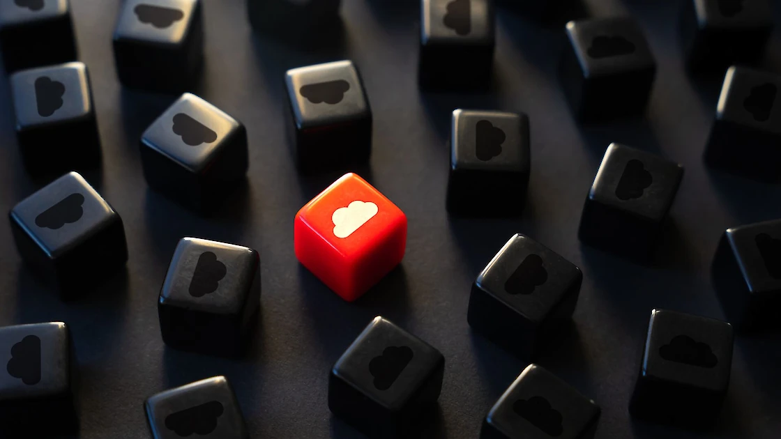 An image of dice with clouds on them, and one of them is red.