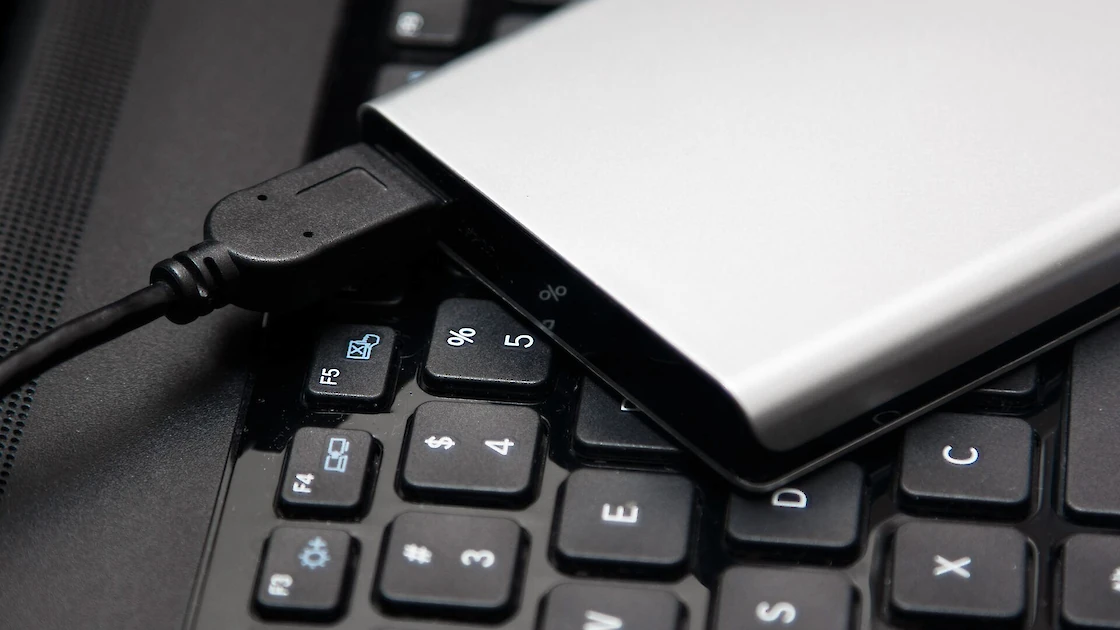 A portable hard drive on a keyboard