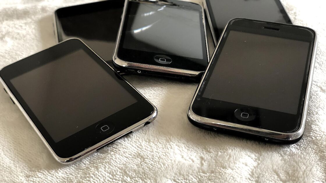 Bunch of older smartphones in a pile on a blanket