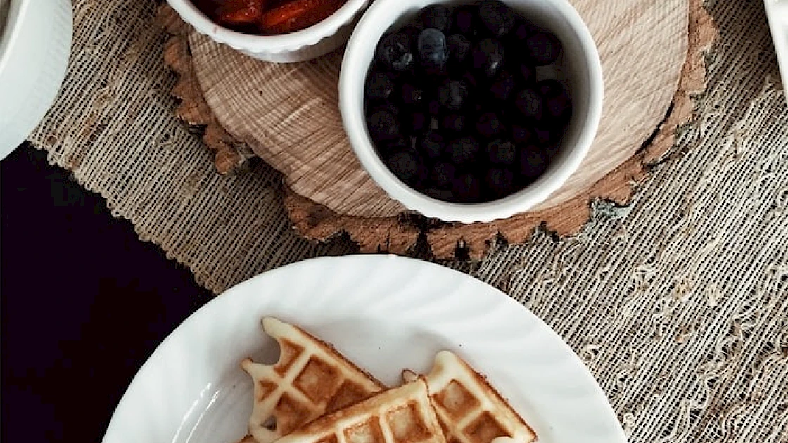 Waffles with fruit toppings on a table top-down perspective