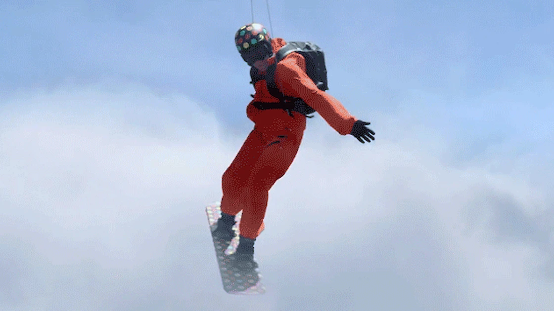 Man in orange jumpsuit hanging from wires and surfing in the clouds