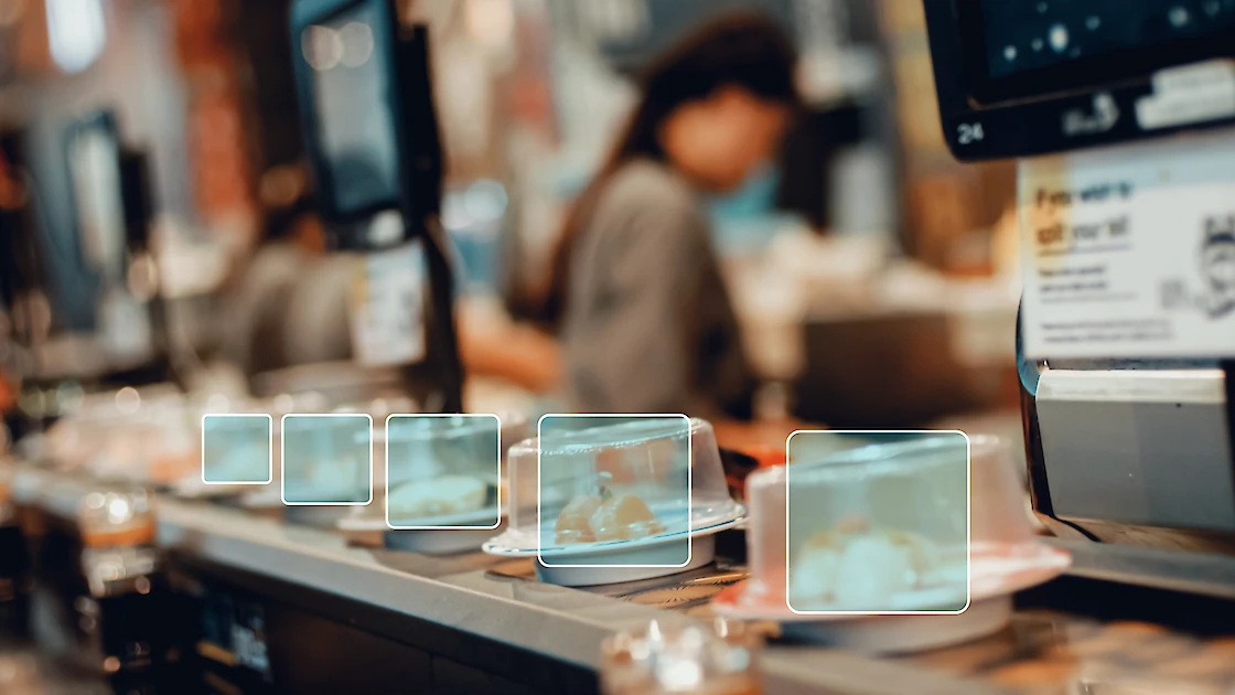 A sushi train being monitored for billing by AI.