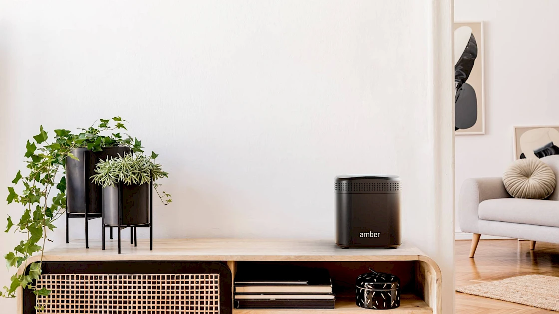 An AmberPRO device in a living room setting.